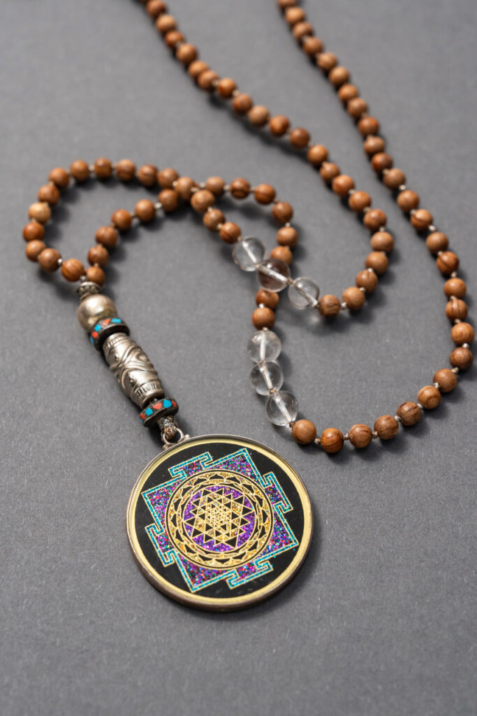 Mala mit Naturholz-Perlen und geometrischem Symbol als Anhänger